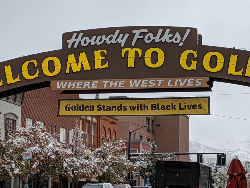 A banner reading "Golden stands with Black lives" hangs from the iconic "Welcome to Golden" sign over Washington Avenue in September 2020.